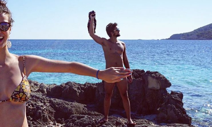 Rodrigo Simas fica pelado em praia e amiga cobre nudez com a mão